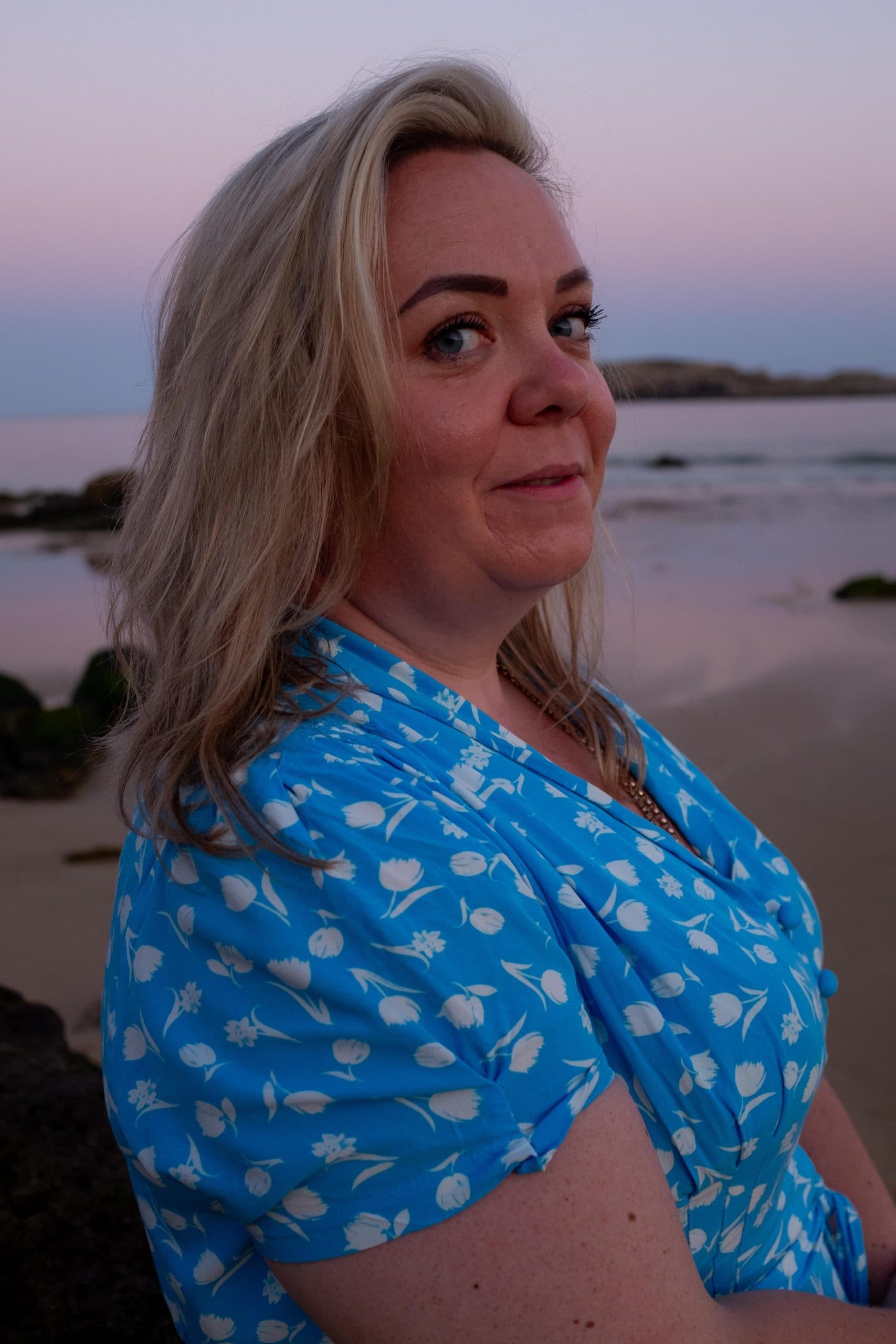 Zoë Dew on a beach at dusk